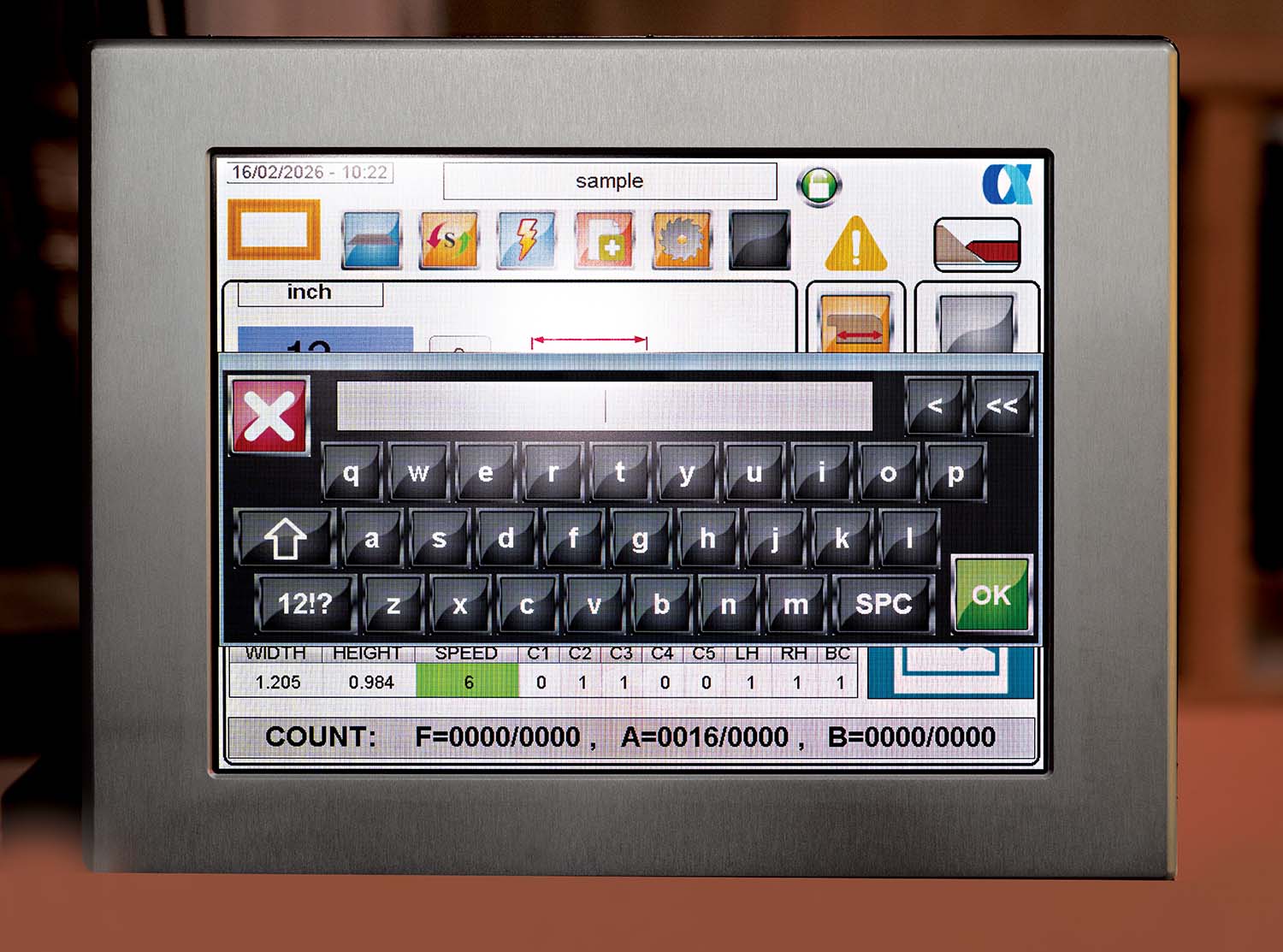 A blue industrial machine with a central control panel and long horizontal arms, designed for precision work.